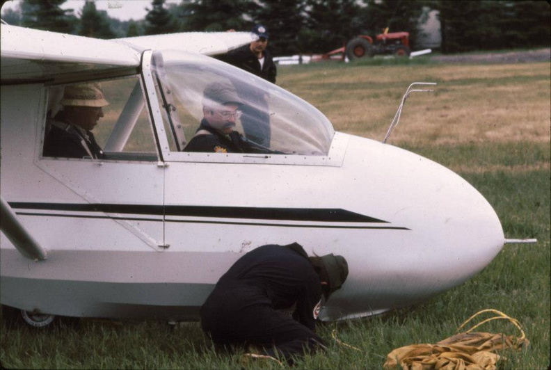 Steve Lazuk is seen holding the port wing. Peter Addison (Cadet CFI) is in rear seat and Bob Little in front. Jake Labonte is attaching cable. 389162_10151371668730952_358028710_n.jpg