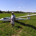 A Man With His Glider in an Alfalfa Field